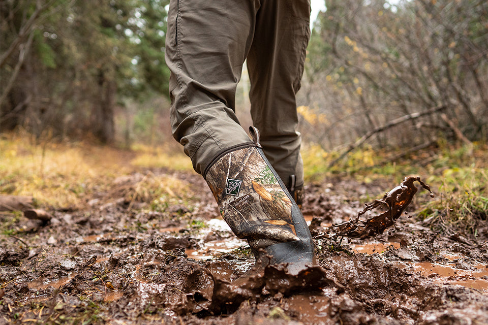 Man walking through muddy terrain in camouflage Fieldblazer boots