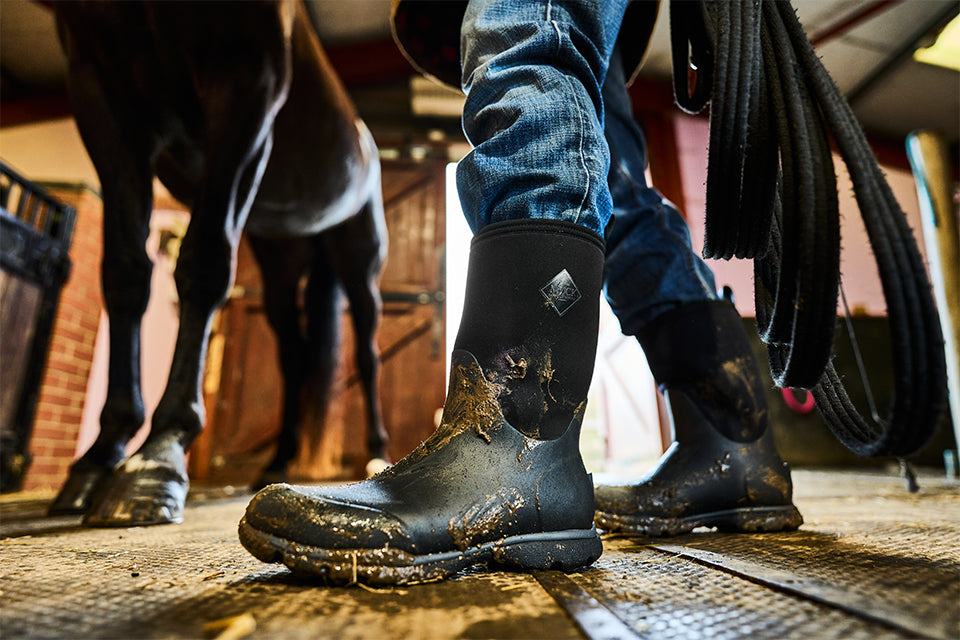 Horse trainer wearing Muck Arctic Excursion Boots