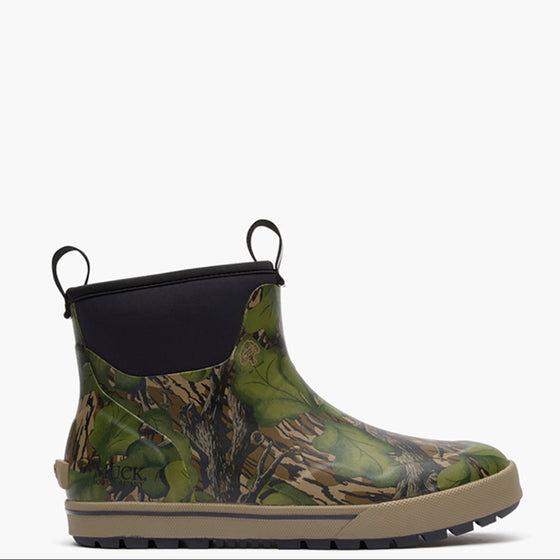 Green camouflage Muck boot with black top on a white background