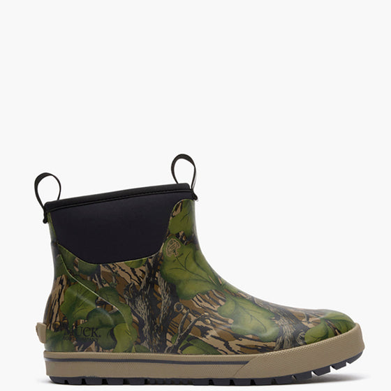 Green camouflage Muck boot with black top on a white background