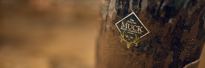 Muck x Bone Collector closeup on collaboration logo and Realtree Original camouflage