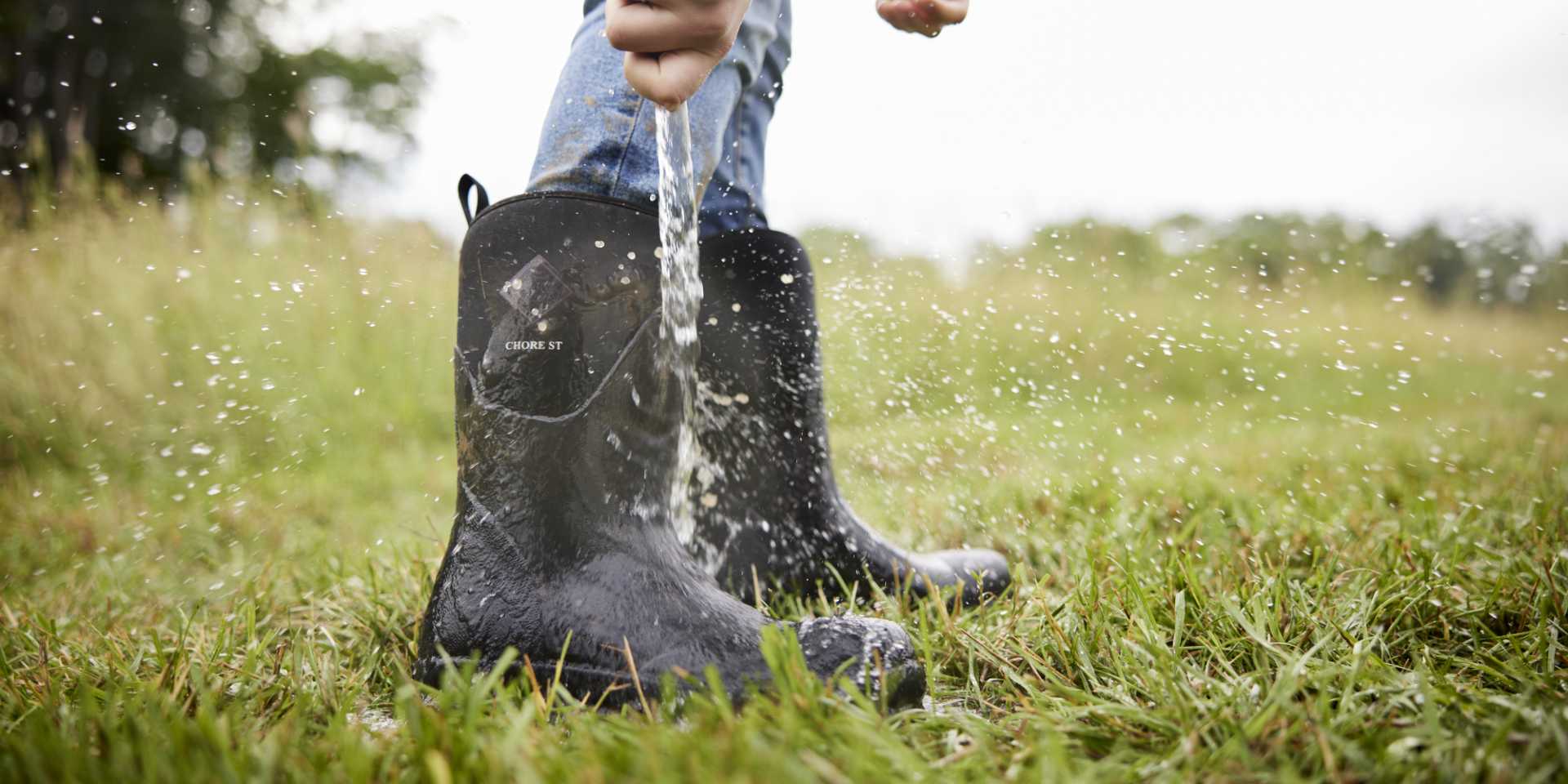 Short Chore Muck Boots being rinsed with water