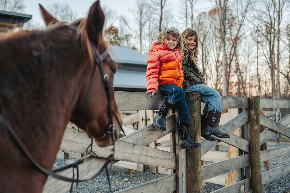 Kids sitting on coral fence