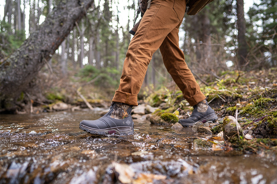 Traversing a rural creek in Apex Mid all terrain boots