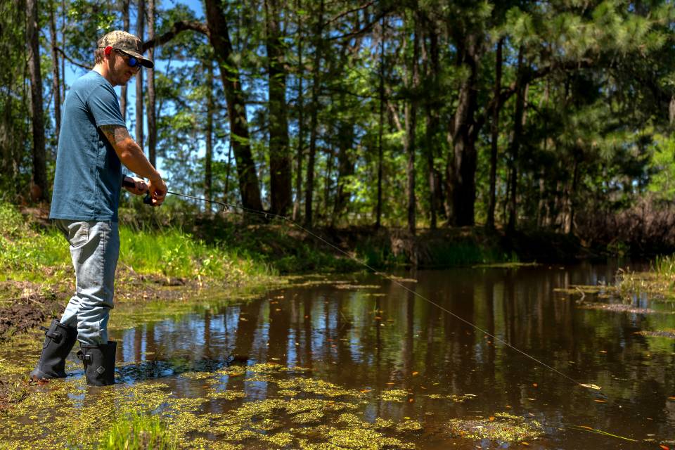 Walking through stream in black boots