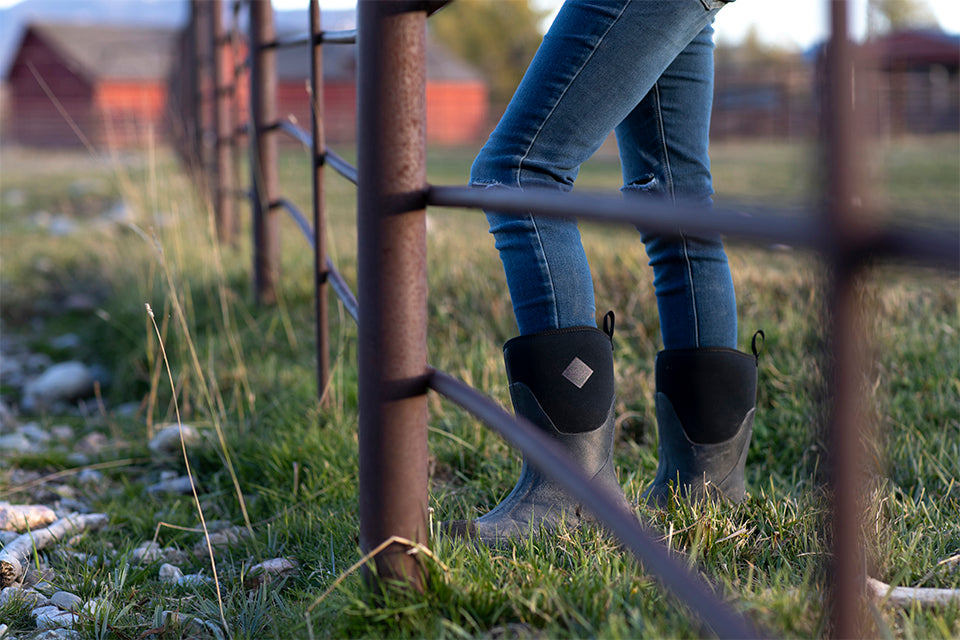 Woman standing by metal fence in Chore Mid women's boots