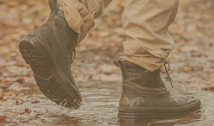 Muck Ankle Boots walking through muddy dirt road