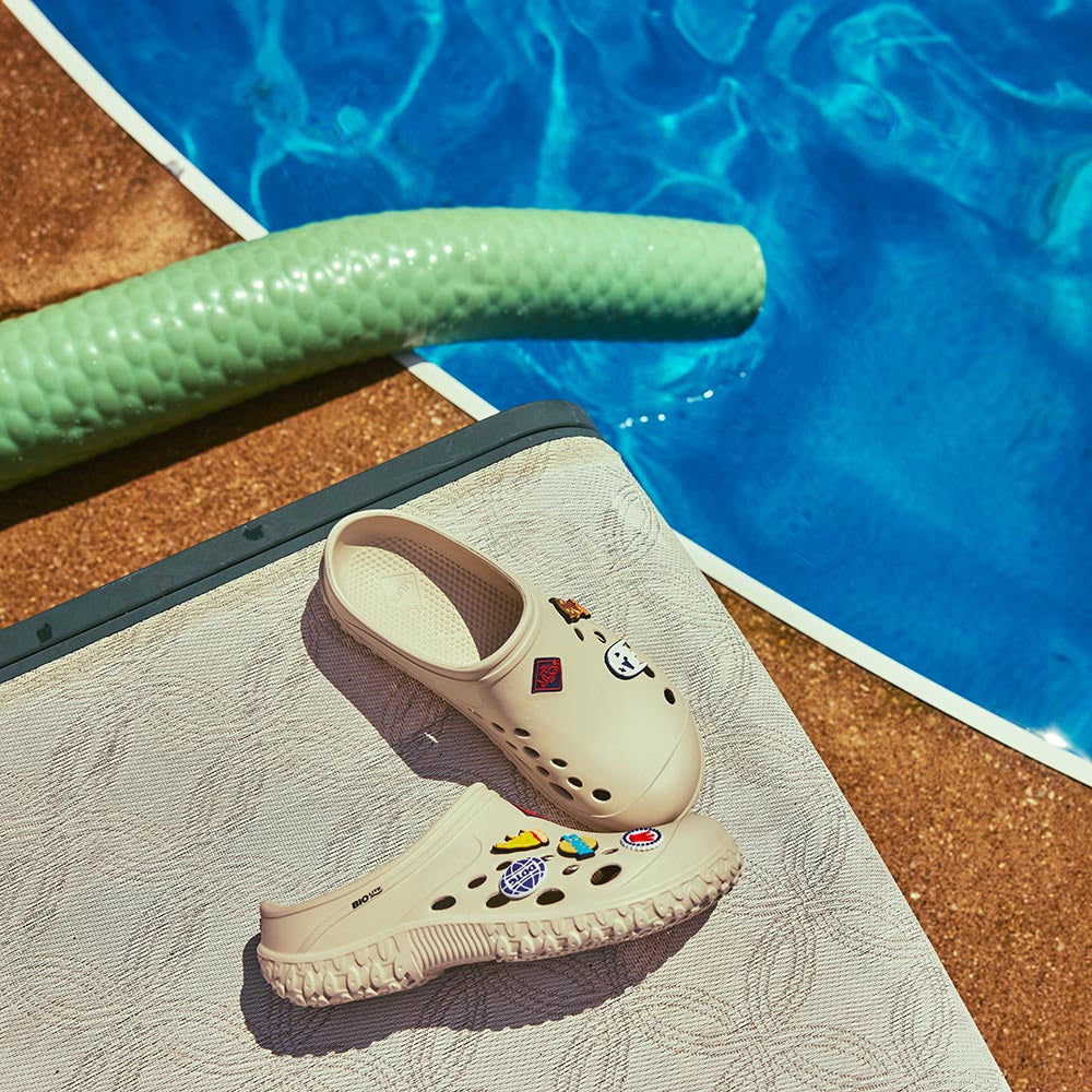 Dave Portnoy Signature Muck Clogs pinned with Barstool Sports flare next to  pool 
