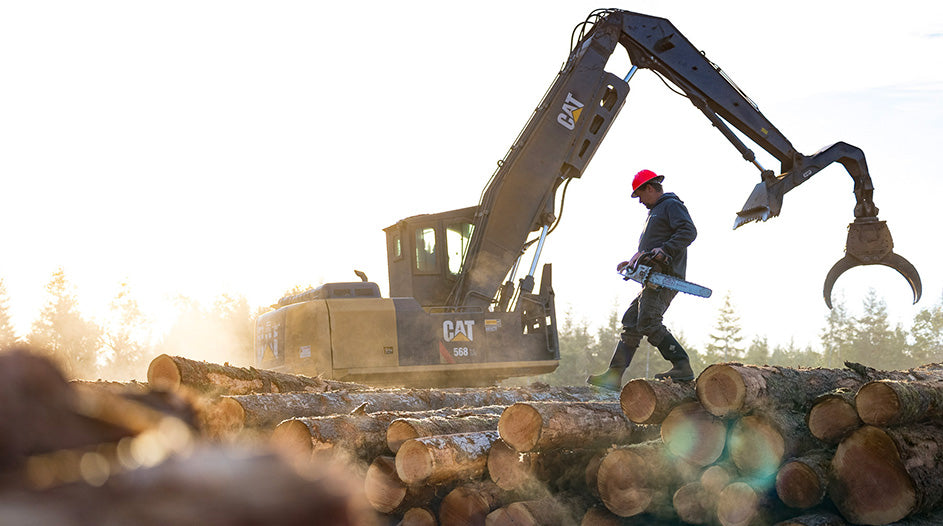 Lumber worker walking on cut tree logs in his Muck Chore Work Boots