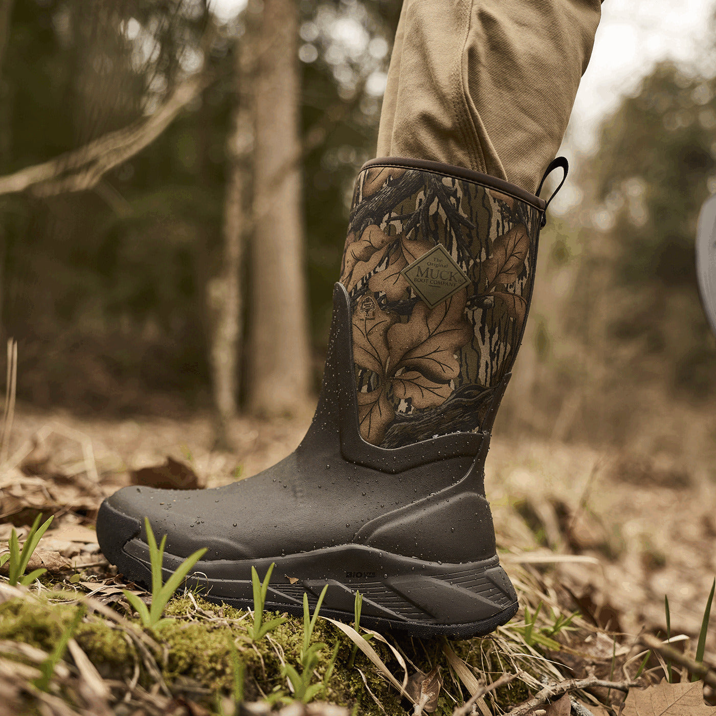Camouflage Muck boot in a forest setting
