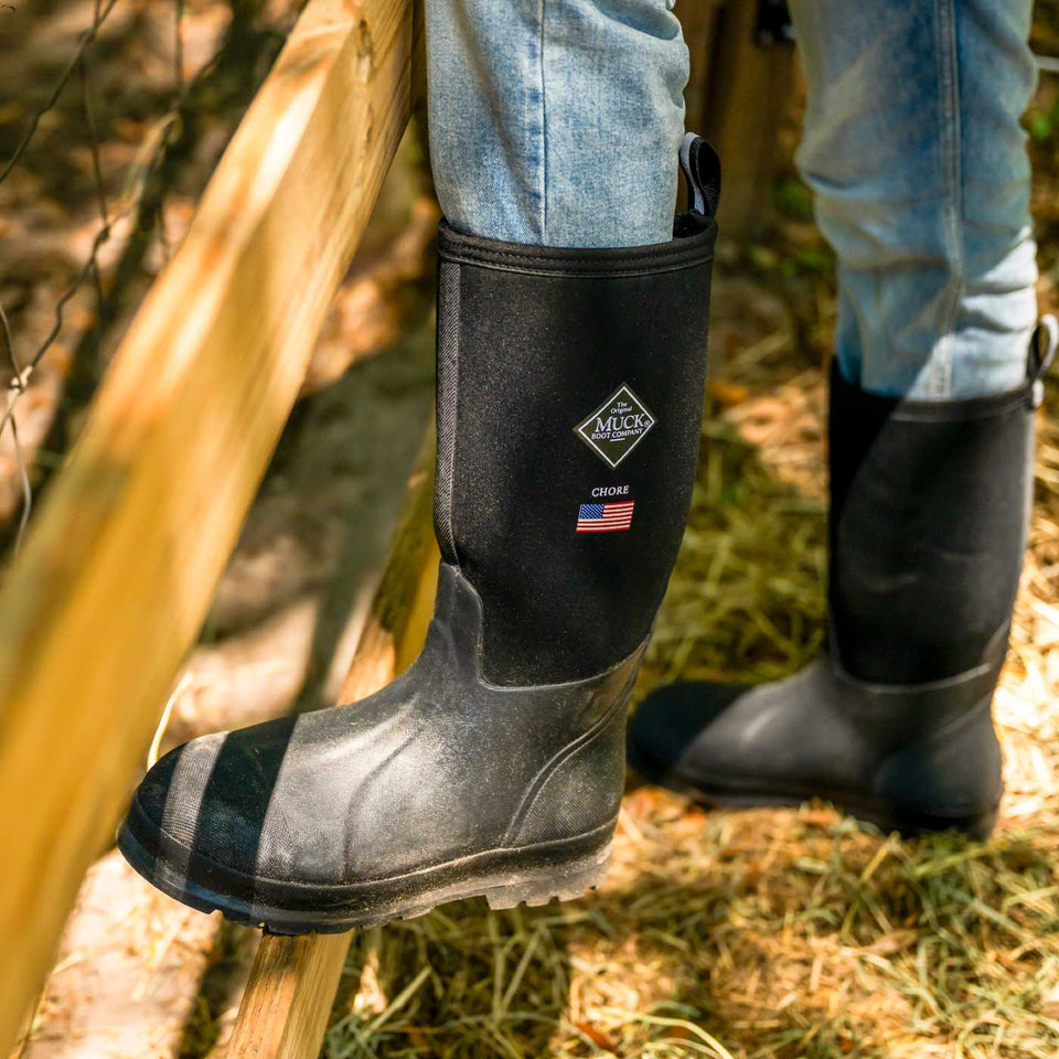 Person wearing CHHUS00 Chore Classic USA Men's Work Boot with  in a farm setting.