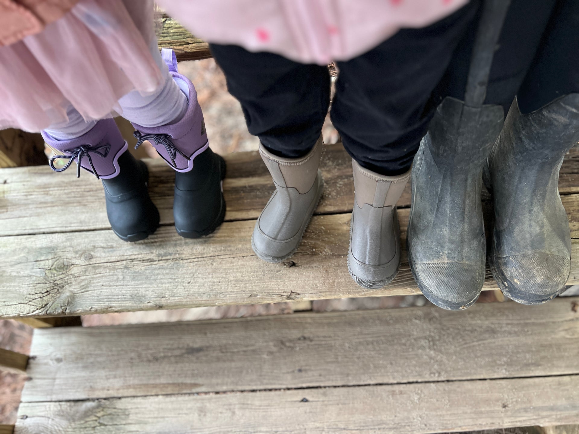 Caitlin G. with her children showing of their Muck Boots.