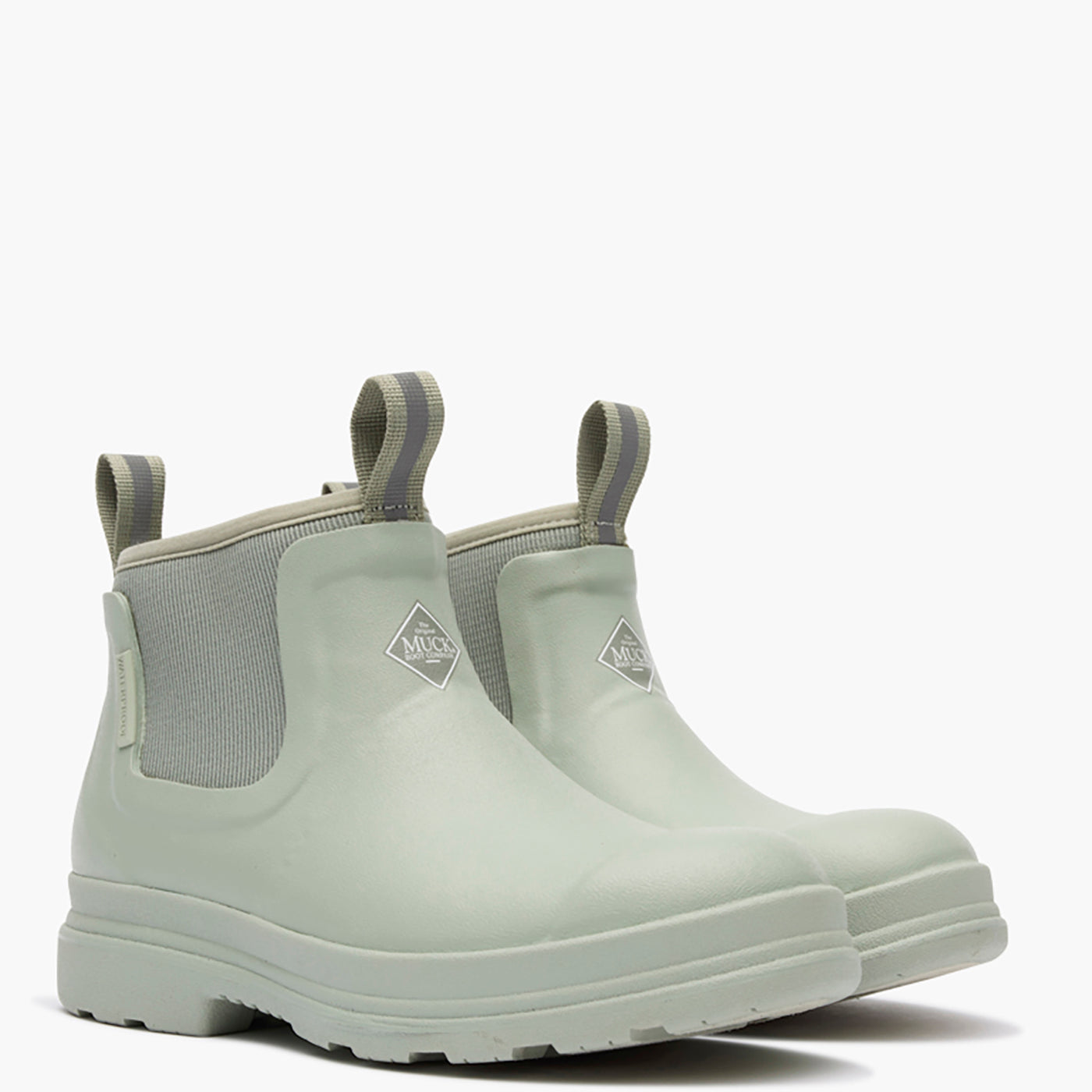 Pair of light green Chelsea boots with gray accents on a white background