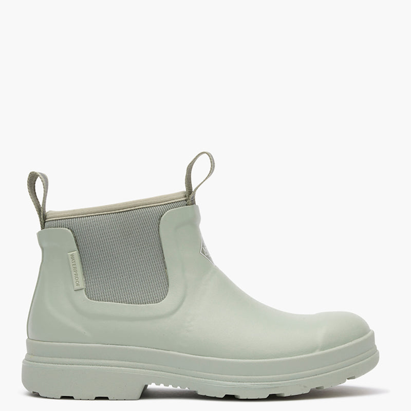Light green rubber boot with elastic side panels on a white background