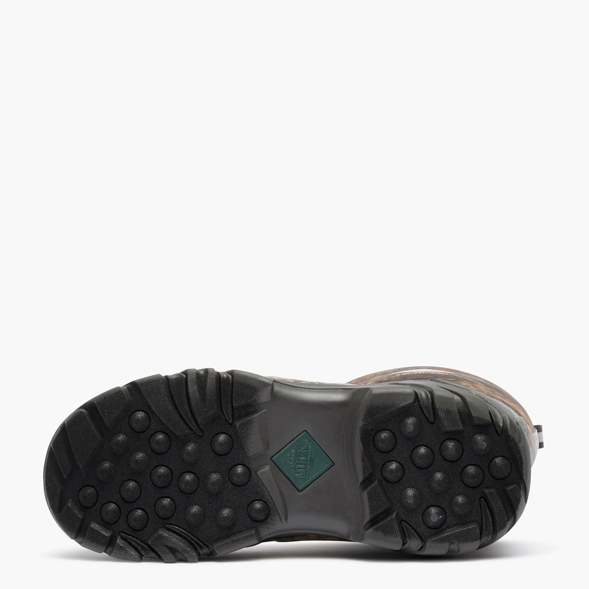 The outsole of a brown boot with a black treaded rubber bottom and a small green diamond-shaped logo patch, shown against a plain white background.