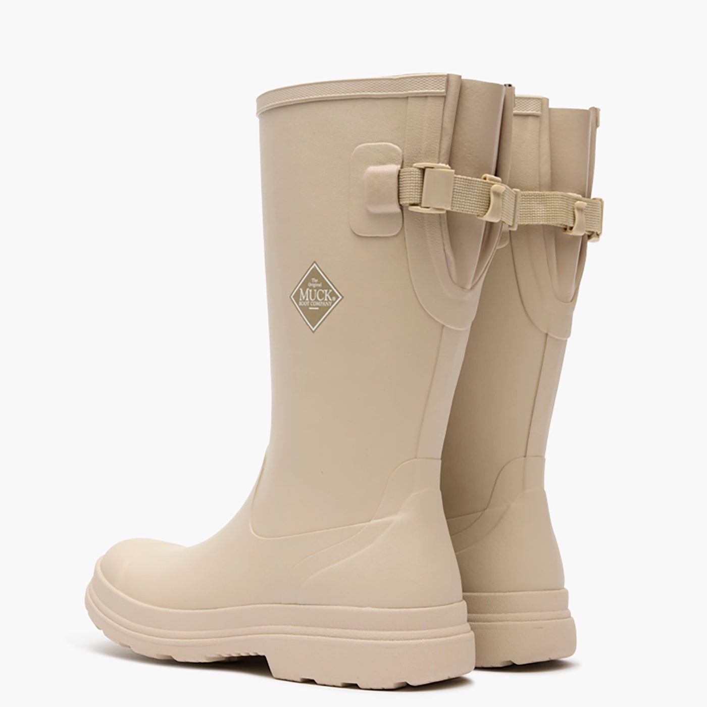 Pair of beige rubber boots with a buckle on a white background