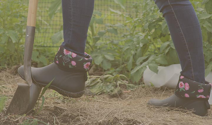 Women using shovel wearing flower printed Muckster II Boots