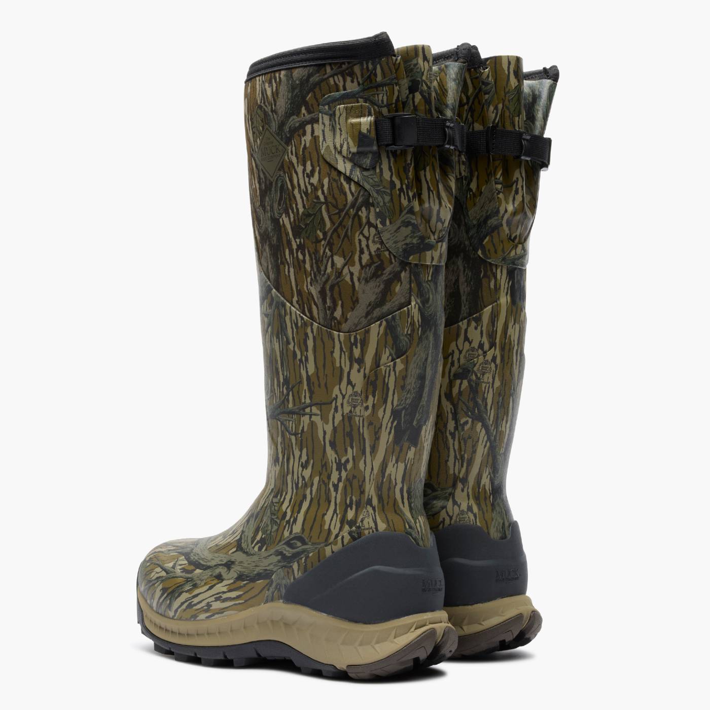 Back angle of pair of Woodland Pro Men's 17" Camo Hunting Boot in Mossy Oak Original Treestand with a bark-style pattern in shades of green, brown, and tan, featuring black buckle straps and dark gray soles.