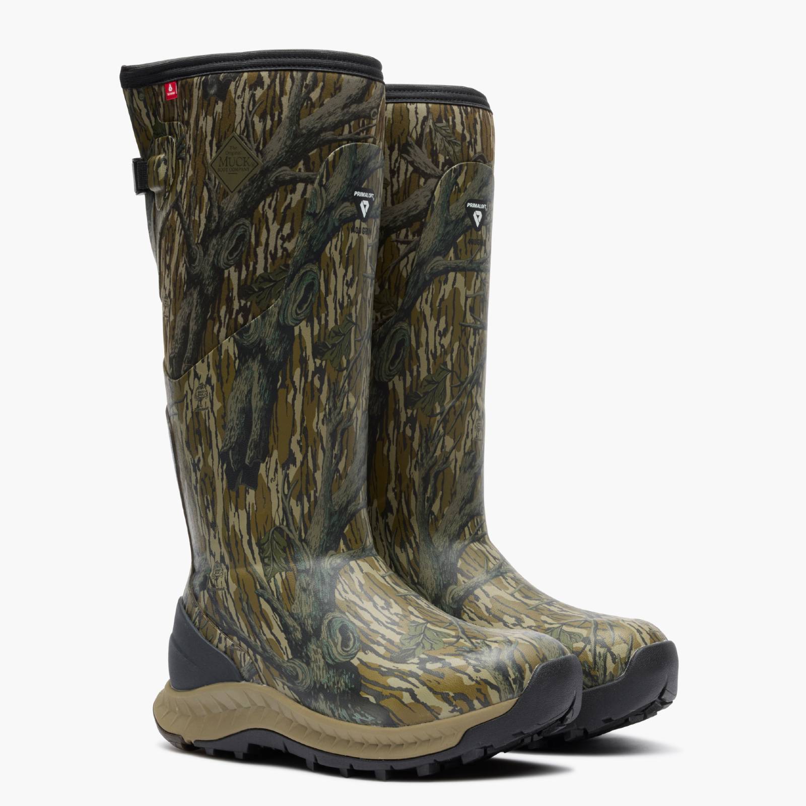 Front, 3-quarter angle view of Woodland Pro Men's 17" Camo Hunting Boot in Mossy Oak Original Treestand realistic tree bark camouflage pattern in shades of brown, green, and beige, featuring black soles and a small red logo tab on the side.