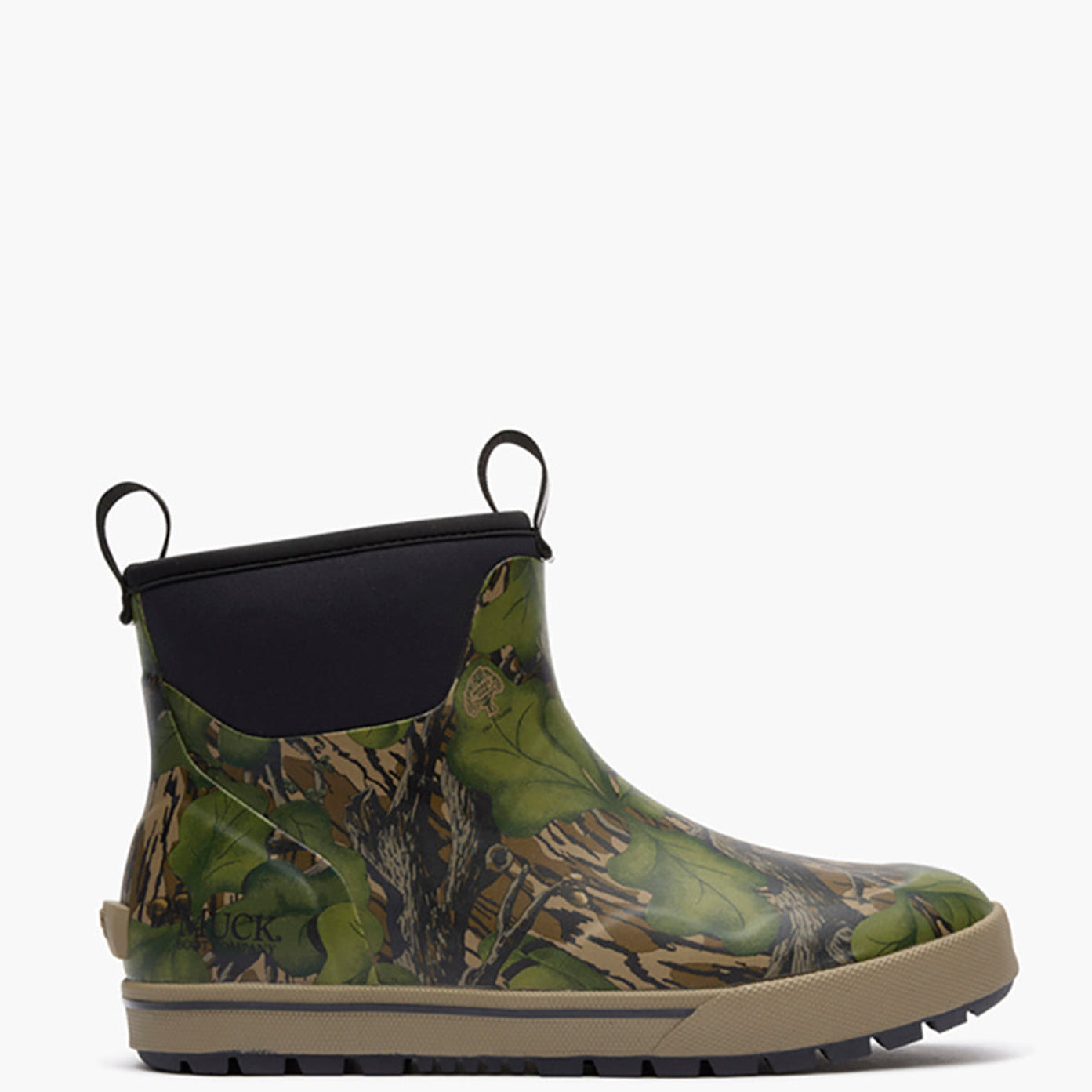 Green camouflage Muck boot with black top on a white background