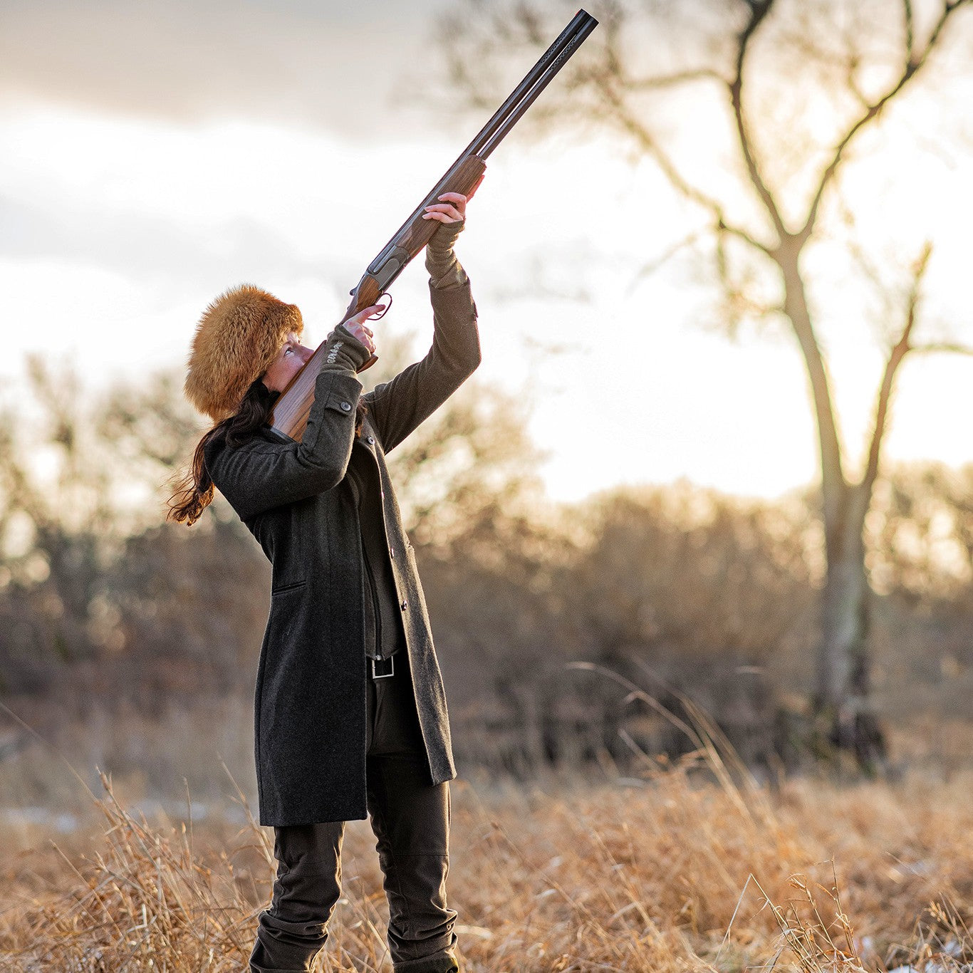 Nathalie Larson shooting her shotgun in the air